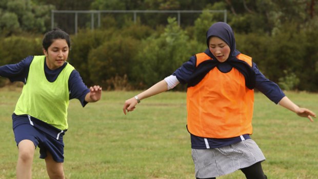 Two girls keep their eyes on the ball during training at Endeavour Hills Secondary College.