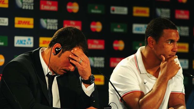 Marc Lievremont the head coach of France (L) and captain Thierry Dusautoir show their dejection at the media conference.