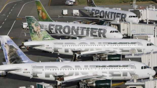 Frontier Airlines planes wait at their gates for the next batch of passengers at Denver airport.