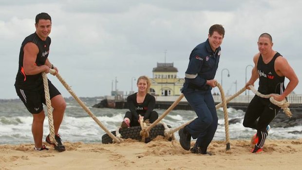 Sweat times: Former AFL footballer Paul Licuria (left), Sara Loh, Ben Marks and Trent Jones at St Kilda beach.