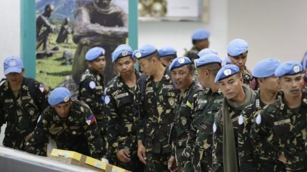Pulled out: Philippine troops, who were deployed in the Golan Heights as UN peacekeepers, arrive home.