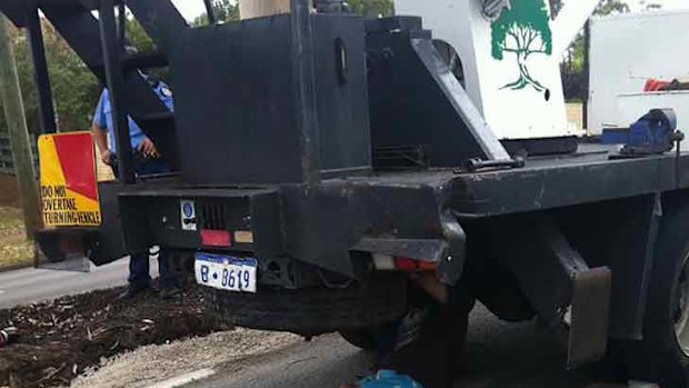 The TRG has been called in to detach a man who has locked himself underneath a cherry picker. He's part of a group protesting a council decision to fell trees in Bentley. Photo: Channel Ten