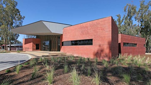 The facade of the Rumbalara Aboriginal Health Clinic is stained in an ochre red.