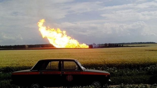 A police car parked beside a field near a fire on the gas pipeline near the village of Iskivtsi in the Lokhvytsia region.