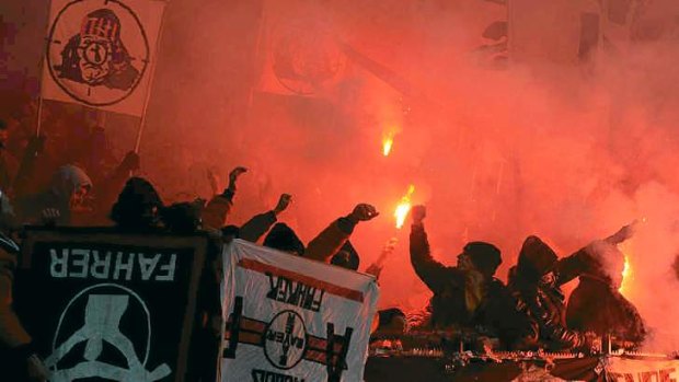 Hooligans hold flares during the German first division Bundesliga football match Bayer Leverkusen and Eintracht Frankfurt on Saturday.