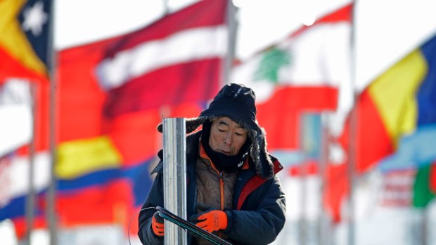 A worker helps set up venues at the PyeongChang Olympic Plaza. About 1200 private security staff have been removed due to a virus.