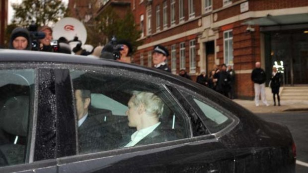 Wanted man ... Julian Assange is driven into Westminster Magistrates Court in London.