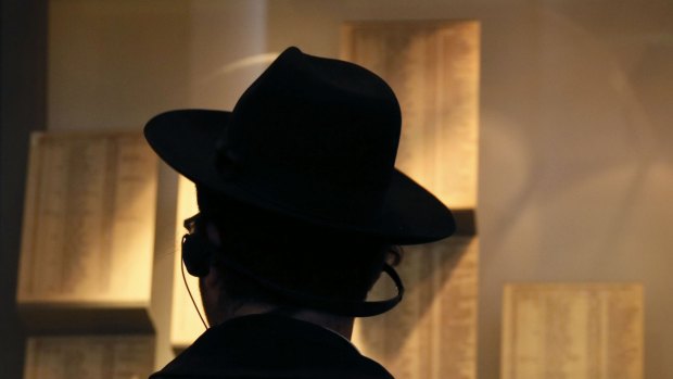 An Orthodox Jewish man looks at facsimiles of Oskar Schindler's lists displayed for the public at the Yad Vashem Holocaust memorial museum in Jerusalem, where the original documents are being stored in the museum's archives.