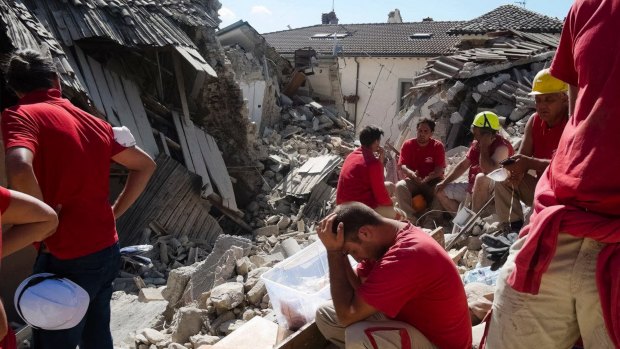 Rescuers pause in Amatrice, central Italy, where a 6.1 earthquake struck in August last year.
