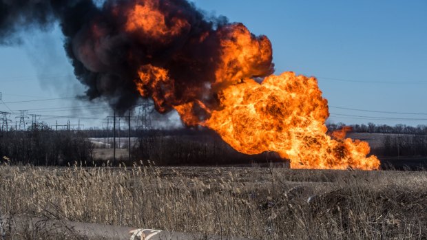 A gas pipe burns after being struck by shelling in Myronivskyi, Ukraine. 