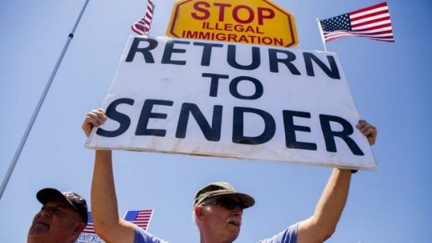 Demonstrators picket against the possible arrivals of undocumented migrants who may be processed at the Murrieta Border Patrol Station in Murrieta, California.