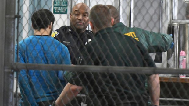 Esteban Santiago, 26, the suspect in the deadly shooting at Fort Lauderdale-Hollywood International Airport, is taken into custody.