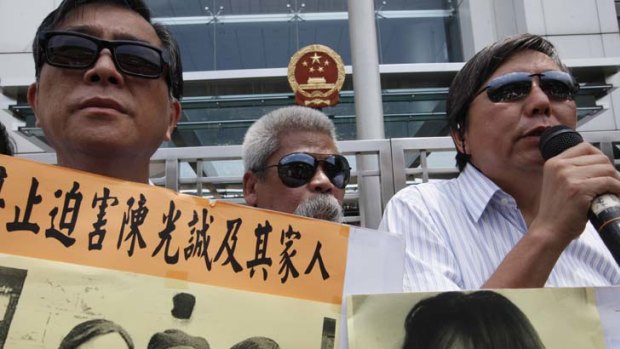 Rally for justice ... pro-democracy protesters in Hong Kong wear sunglasses as a gesture of support for the blind human rights advocate Chen Guangcheng.