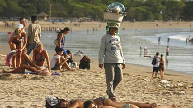 Sunbathing on Kuta beach. After a drop-off after the first terrorist bombing, tourist numbers in Bali are at record levels.