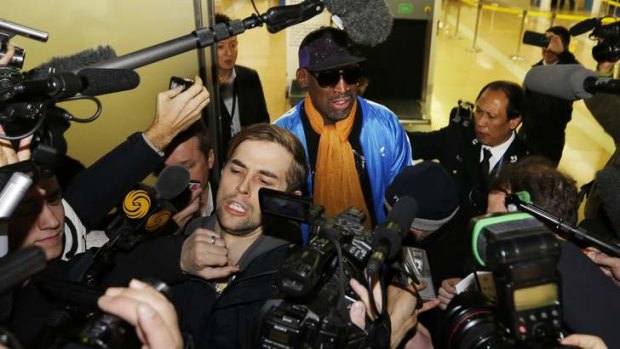 Former NBA basketball player Dennis Rodman speaks to the media upon his arrival from North Korea's Pyongyang, at Beijing Capital International Airport.