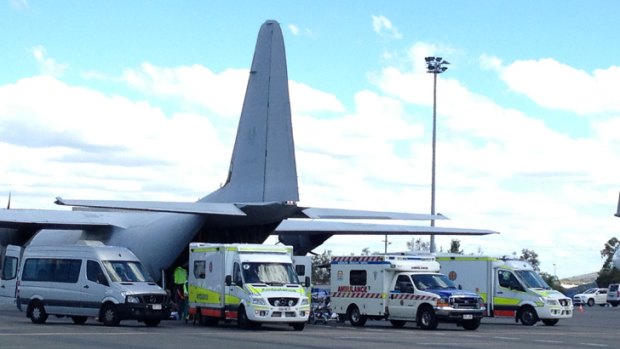 Ambulances line up near the plane at Brisbane Airport.