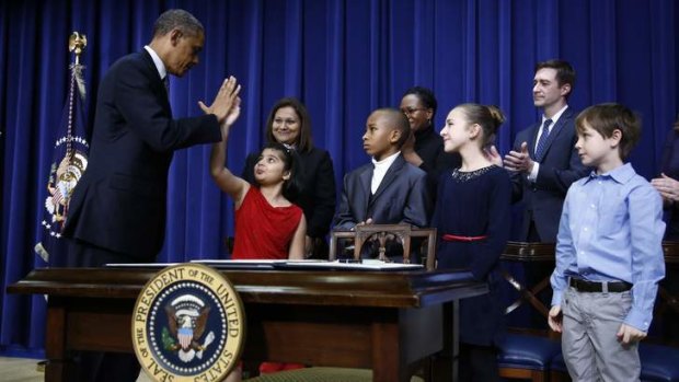 Done &#8230; President Obama high-fives eight-year-old Hinna Zejah after unveiling a series of gun control proposals at the White House.