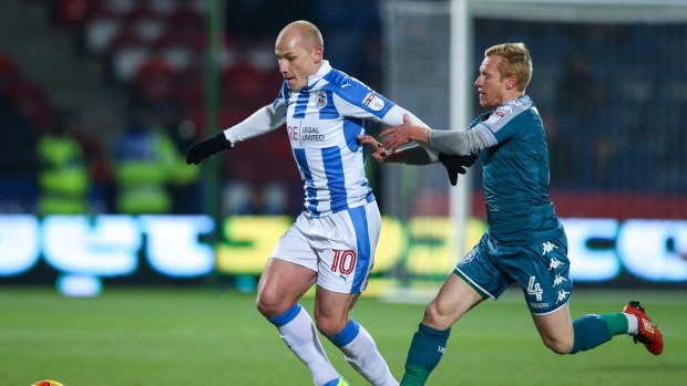 On loan: Manchester City's Aaron Mooy, left, playing for Huddersfield Town against Wigan Athletic in England's second tier.