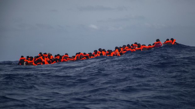Sub-saharan migrants wait to be rescued by aid workers in the Mediterranean Sea. 
