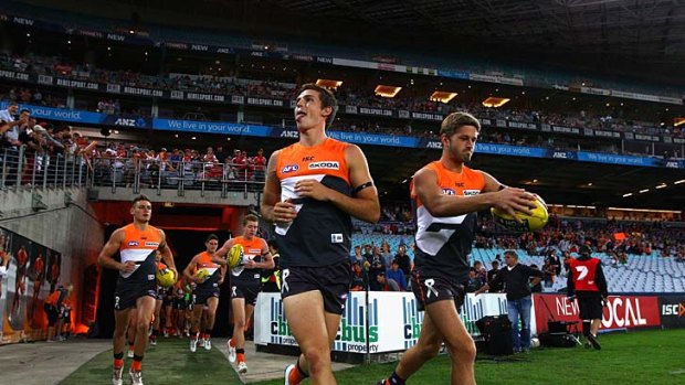 Here we come: Phil Davis and Callan Ward lead the Giants onto the ground last night.