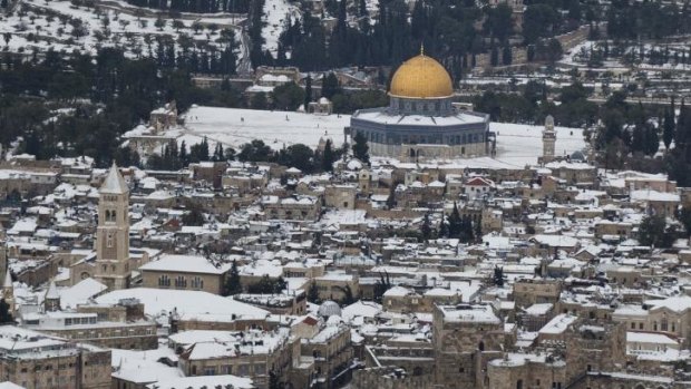 Thick blanket: Snow covers Jerusalem's old city on Saturday, causing traffic disruptions and power outages across the country.