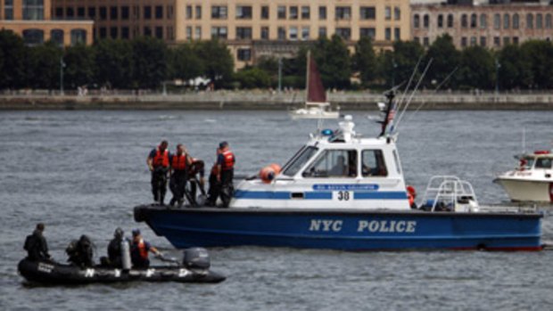 Rescue officials search along the Hudson River.