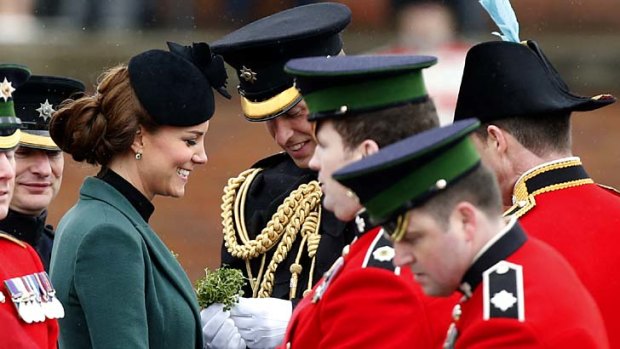 Celebrating St Patrick's Day: Kate and Prince William before presenting traditional sprigs of shamrock to members of the 1st Battalion Irish Guards.