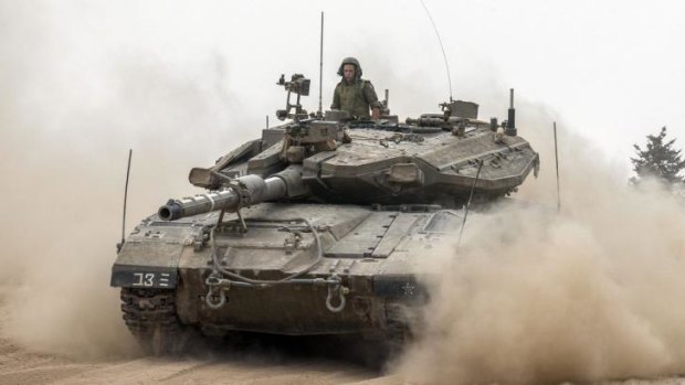 An Israeli Merkava tank moves towards the Israeli-Gaza border on Saturday.