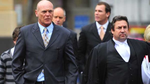 Former AFL footballer Wayne Carey (second from right) gives evidence in court for brother Dick (far left) yesterday.