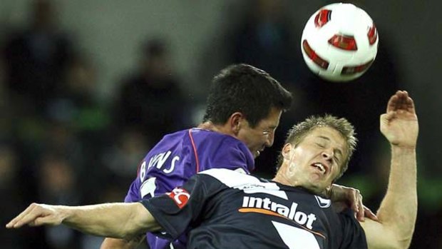 Jacob Burns of Perth (left) and Victory's Adrian Leijer battle for the ball.