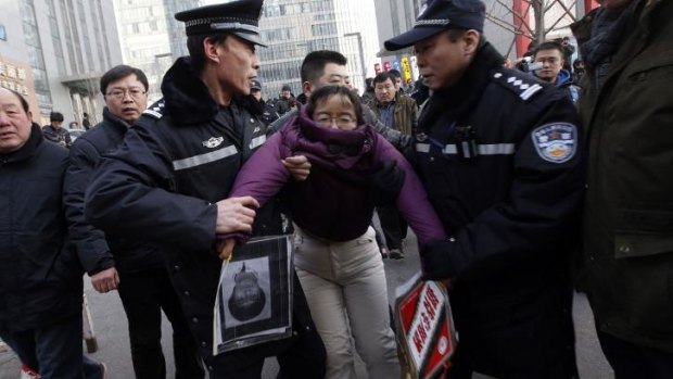 Protest: A supporter of Xu Zhiyong is detained by policemen near the court.