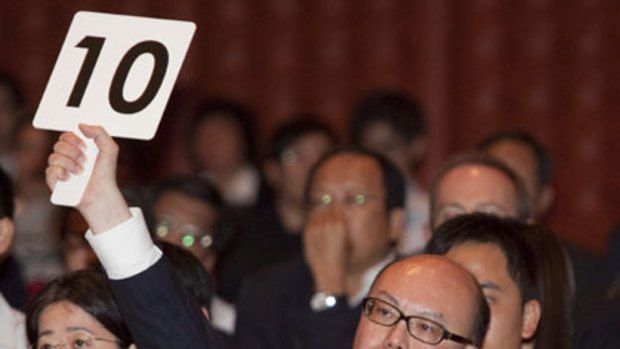 Donald Choi, managing director of Nan Fung Development, makes the winning bid during a government land auction in Hong Kong.