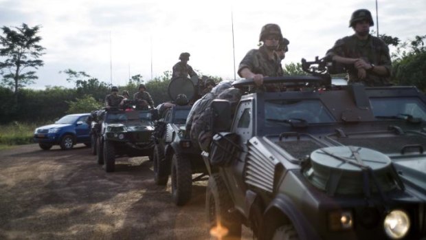 French militaries drive on a road to Central African Republic.