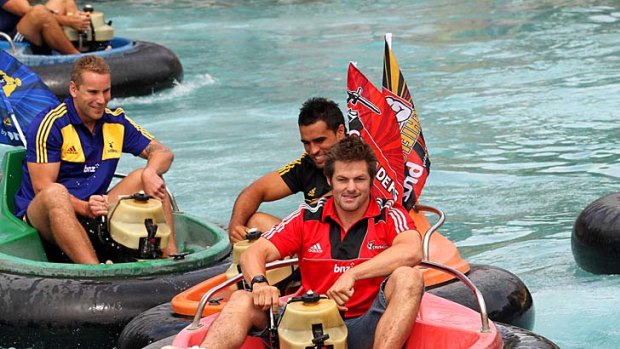 Richie McCaw of the Crusaders leads Jarrad Hoeata of the Highlanders (left) and Lia Messam of the Chiefs in the bumper boats race after the New Zealand 2012 Super Rugby season launch in Auckland this week.