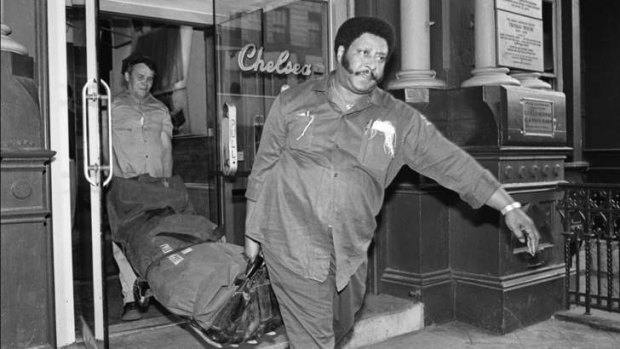 Checking out: Nancy Spungen's body is taken from the hotel after her murder by Sid Vicious.