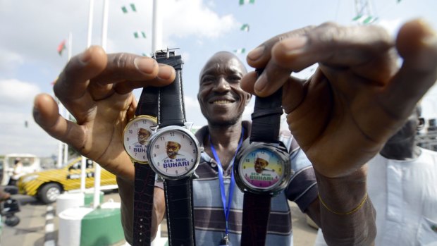 A vendor sells wrist watches with portraits of Nigerian President  Mohammadu Buhari in Abuja.