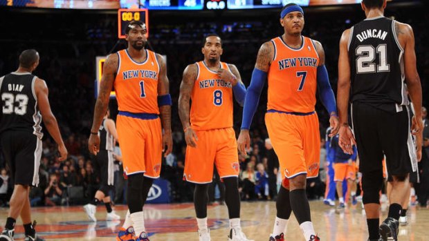 Carmelo Anthony #7 of the New York Knicks and his teammates J.R. Smith #8 and Amar'e Stoudemire #1 were far from happy after losing to San Antonio.
