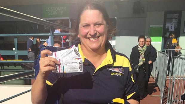 Debbie Greaves is all smiles with the coveted tickets in hand.