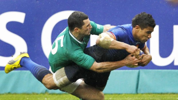 Wesley Fofana of France crashes over for a try despite the tackle of Rob Kearney.