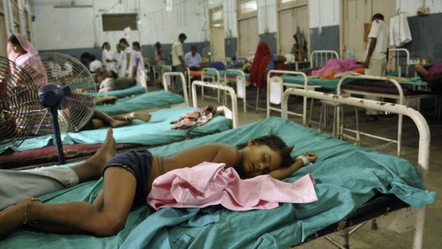 Indian children who fell sick after eating a free school lunch lie at a hospital in Patna, India.