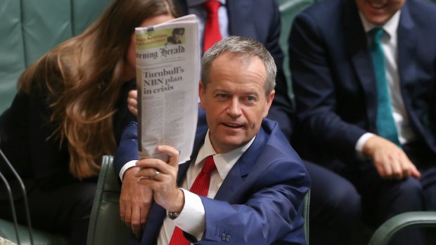 Opposition Leader Bill Shorten holds up a copy of the Fairfax report in question time on Monday. 