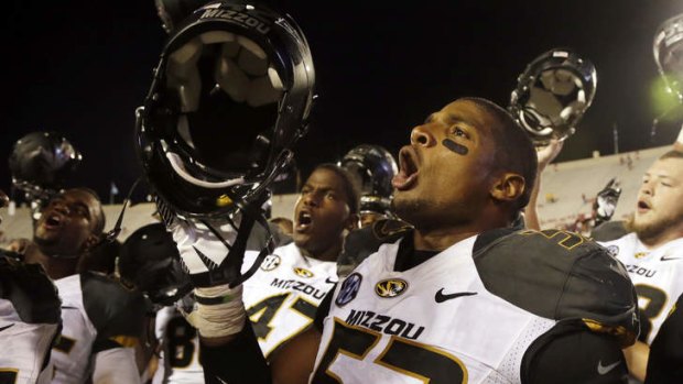 Michael Sam sings the school song after Missouri defeated Indiana in an NCAA college football game in Bloomington, Indiana.