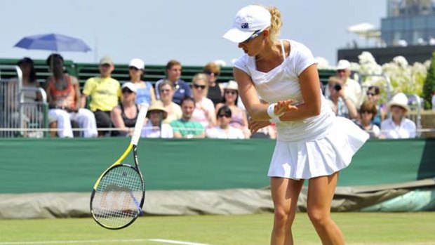 Anastasia Rodionova throws her racquet to the ground after missing a point against China's Li Na.
