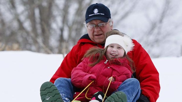 Recovering well ... Alannah Shevenell, rides a sled with her grandfather.
