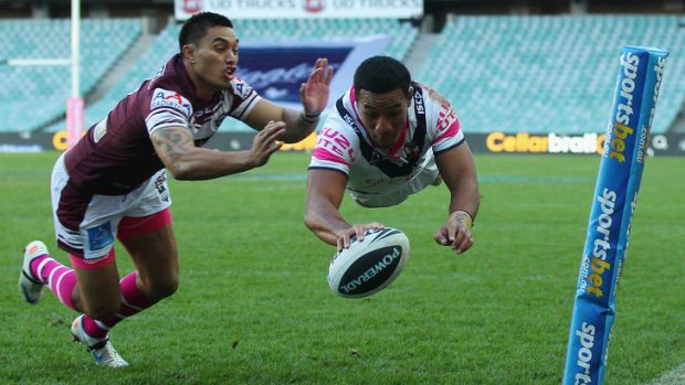 Tautau Moga of the Roosters scores a try.