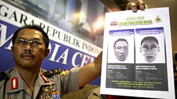 Indonesian police spokesman Nanan Sukarna shows a sketch of the JW Marriott and Ritz-Carlton hotel suicide bombers.