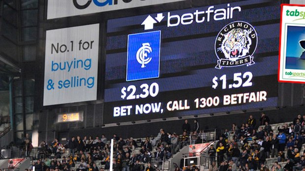Sports betting is now advertised on scoreboards (digitally altered image, above). The TAB Sportsbet website (inset).