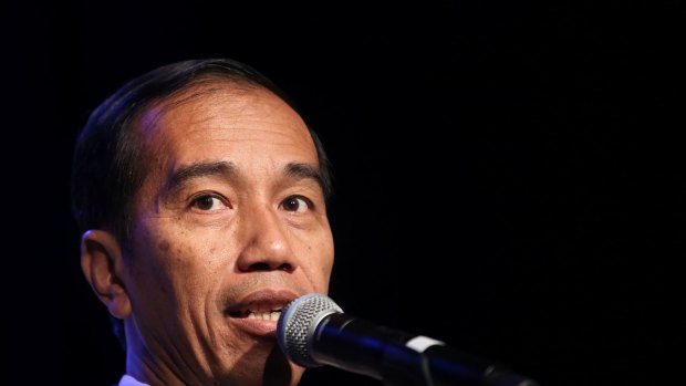 Members of Australia's Indonesian community listen intently to a speech by visiting Indonesian Presidednt, Joko Widodo addressing the crowd at the Sydney Convention Centre.