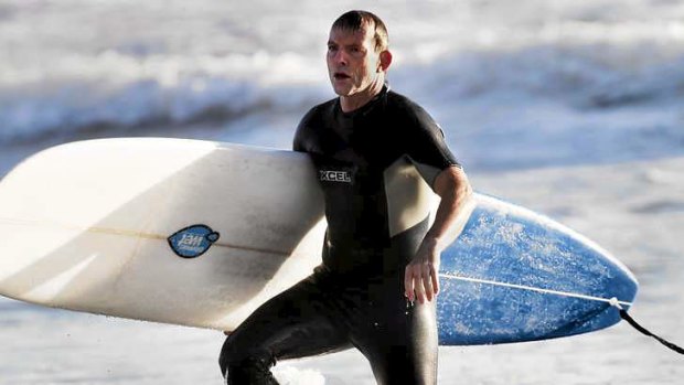 Prime Minister Tony Abbott enjoys a break from his duties with a surf at Manly.