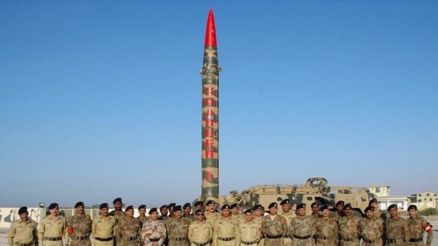 Firepower: Pakistani army officials in front of a nuclear-capable Hatf 4 (Shaheen-1) missile during a test launch in 2006.
